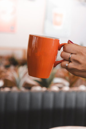 A cozy corner with a steaming cup of coffeeの写真素材