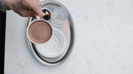 Freshly brewed coffee served in a stylish cupの写真素材