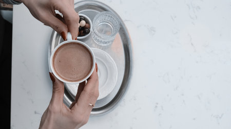 Freshly brewed coffee served in a stylish cupの写真素材