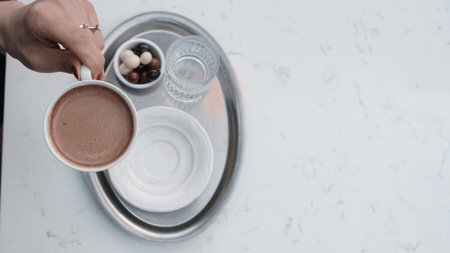 A steaming cup of coffee on the tableの写真素材