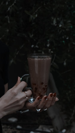 A steaming cup of coffee on the tableの写真素材