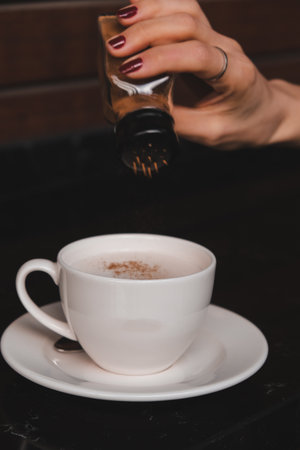 A steaming cup of coffee on the tableの写真素材