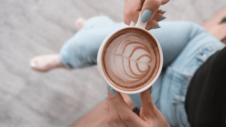 A steaming cup of coffee on the tableの写真素材