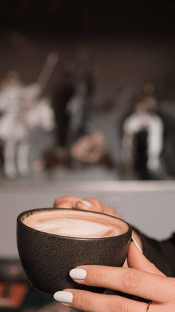 A steaming cup of coffee on the tableの写真素材