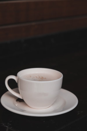 A cozy corner with a steaming cup of coffeeの写真素材