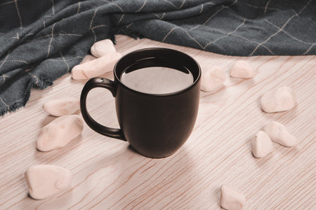 A cozy corner with a steaming cup of coffeeの写真素材