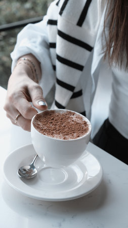 Freshly brewed coffee served in a stylish cupの写真素材