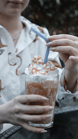 A steaming cup of coffee on the tableの写真素材