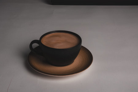 A steaming cup of coffee on the table