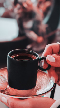 A steaming cup of coffee on the tableの写真素材