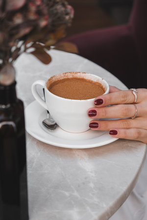A steaming cup of coffee on the tableの写真素材