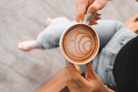 A steaming cup of coffee on the tableの写真素材