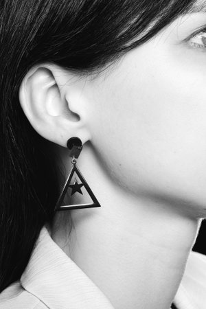 Beautiful black geometric earring with star and triangle shapesの写真素材
