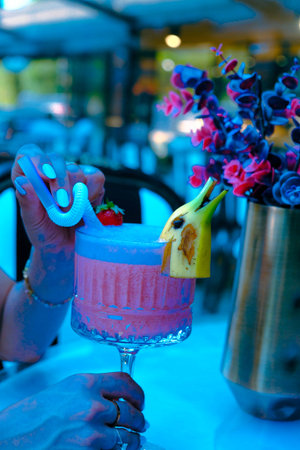 Cocktail glasses filled with vibrant, colorful drinksの写真素材