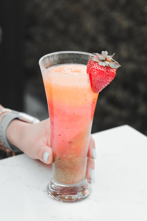 Cocktail glasses filled with vibrant, colorful drinksの写真素材