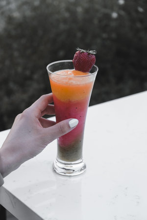 Cocktail glasses filled with vibrant, colorful drinksの写真素材