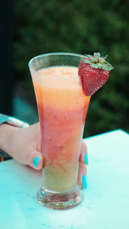 Cocktail glasses filled with vibrant, colorful drinksの写真素材