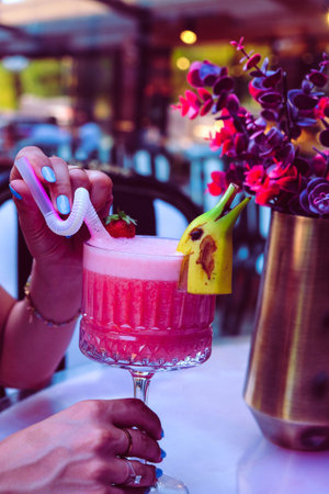 Cocktail glasses filled with vibrant, colorful drinksの写真素材