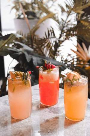 Cocktail glasses filled with vibrant, colorful drinksの写真素材