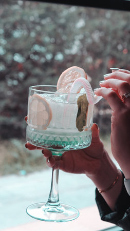Cocktail glasses filled with vibrant, colorful drinksの写真素材