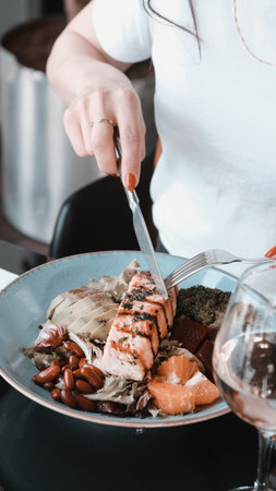 Fried fish on white plate with onion, garden rocket and lemon slicesの写真素材