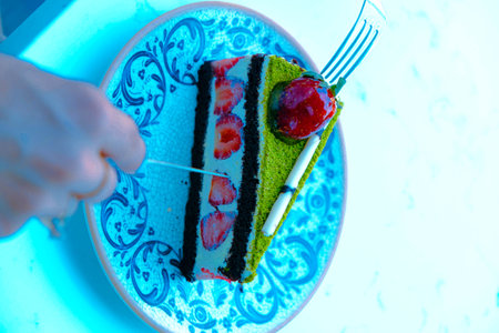 Colorful Fruit Topped Cake on White Backgroundの写真素材