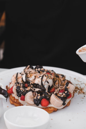 Delicious waffles with chocolate sauce