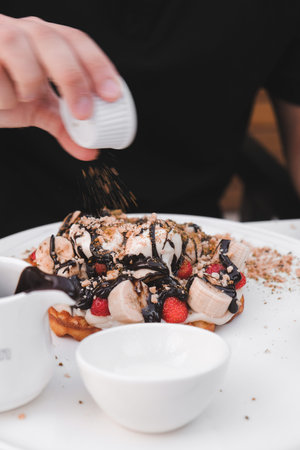 Delicious waffles with chocolate sauce