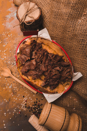 Baked kumpir potato stuffed with the cheese, sausage, olives, peppers and cornの写真素材