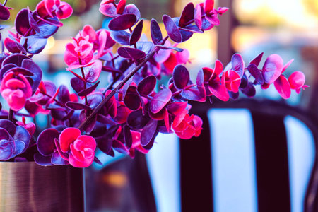 Beautiful flowers in a vase on a table in a cafeの写真素材