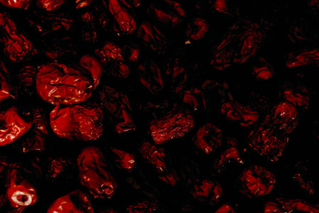 Dried red dates on a black background. Close-up.の写真素材