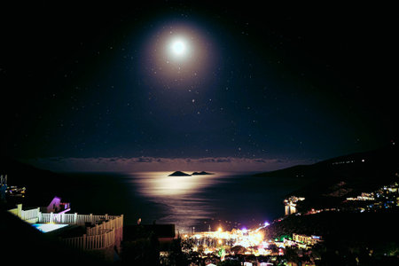 Night view of the sea and the starry sky with a moonの写真素材