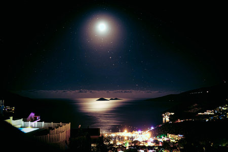 Moon in the sky over the sea. Night starry sky.の写真素材