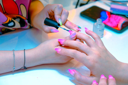 Manicure process in a beauty salon. Nail filing.の写真素材