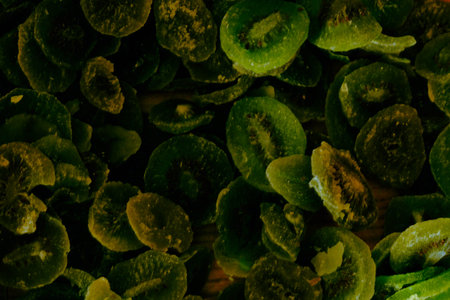 Dried kiwi slices on wooden background. Toned.の写真素材