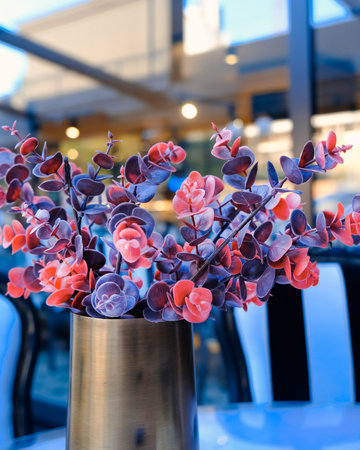 Red succulent plant in a vase on a table in a cafeの写真素材