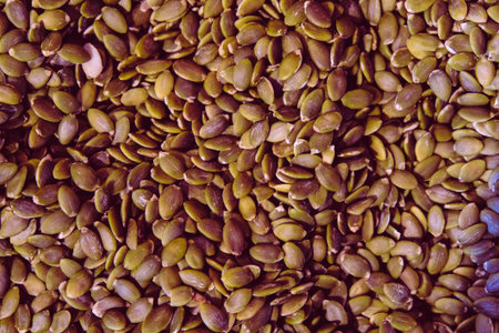 Close up of green flax seeds background. Healthy food concept.