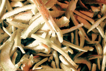 close up of a pile of dried orange peel in sepia tone