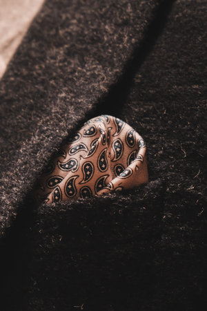 Closeup detail of a brown wool coat with a pattern on it