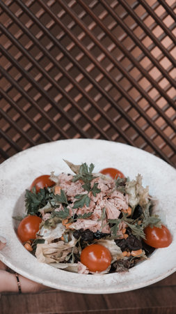 Plate with mixed greens and tomatoesの写真素材