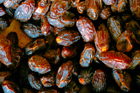 Dried fruit dates on a black background. Close-up.