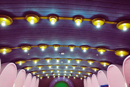 Interior of a modern building with ceiling lamps in blue tones.の写真素材
