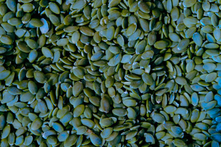Pumpkin seeds background. Close up of green pumpkin seeds.