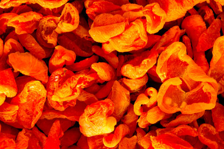 Pile of dried apricots background, closeup of photo