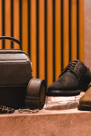 Men's accessories on a marble background. Men's shoes, bag, belt, glasses.