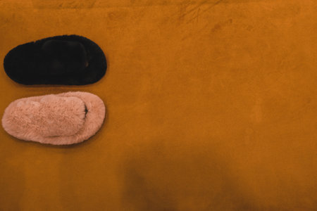 Top view of slippers on orange suede backgroundの写真素材