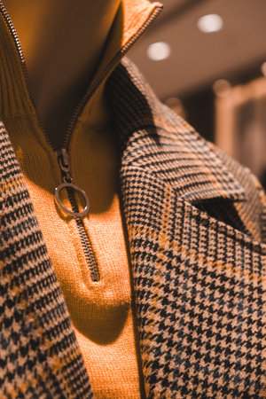 Clothing store window display with coat and necktie