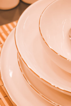 Close up of a stack of porcelain dishware on the table