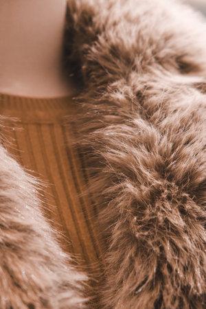 Close-up of woman's waist in fur coat. Selective focus. Toned.の写真素材