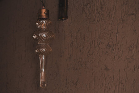 Vintage light bulb hanging on the wall, vintage tone.